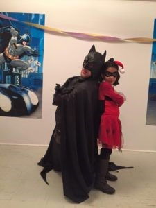 Batman entertainer posing with a child during a kids superhero birthday party in Toronto