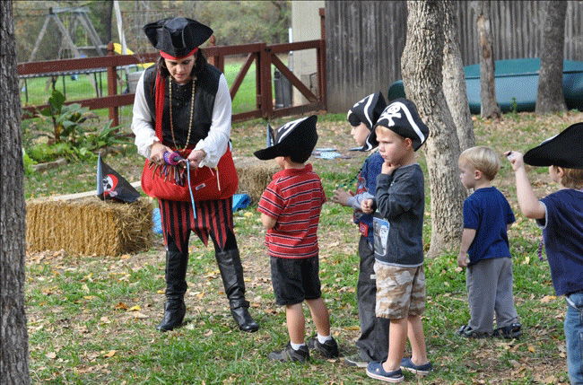 Pirate entertainer guiding a small group of children during a structured daycare pirate show in Toronto