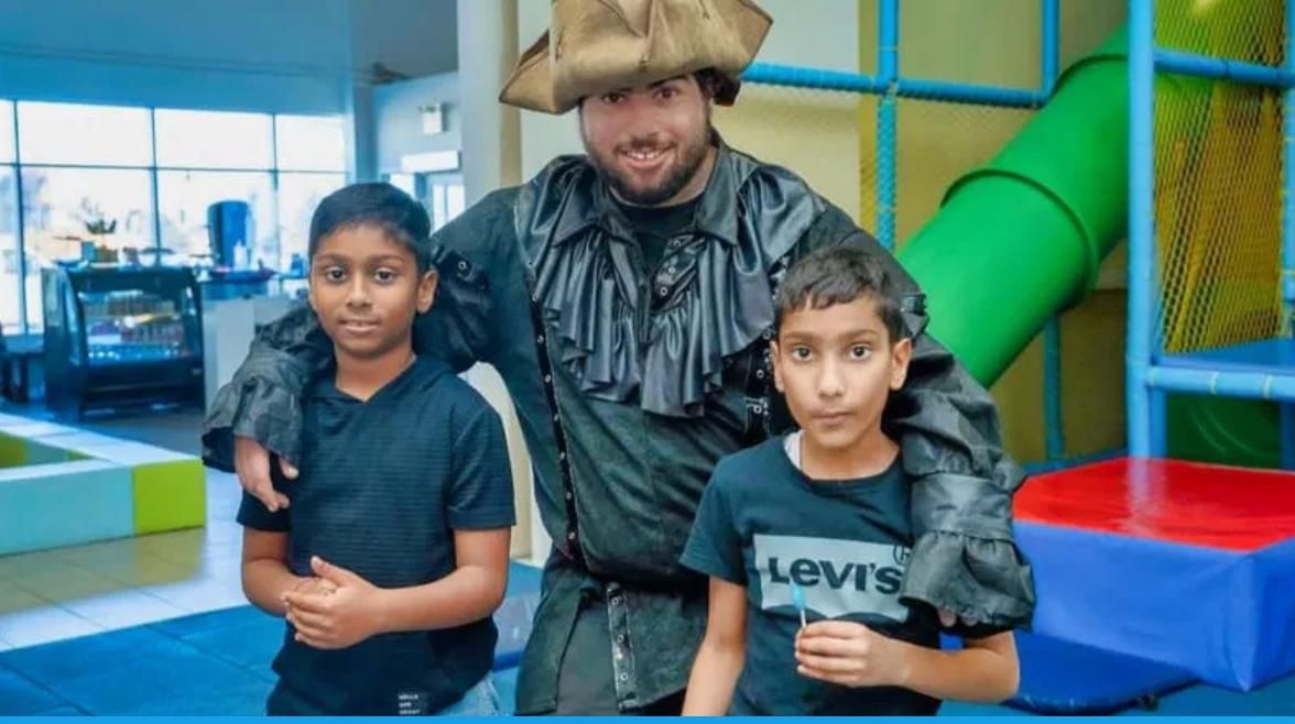 Pirate party entertainer posing with children during a kids birthday party in Toronto