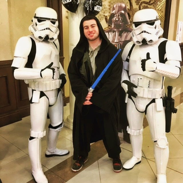 Themed adventure party characters posing for a photo with a guest during a kids event