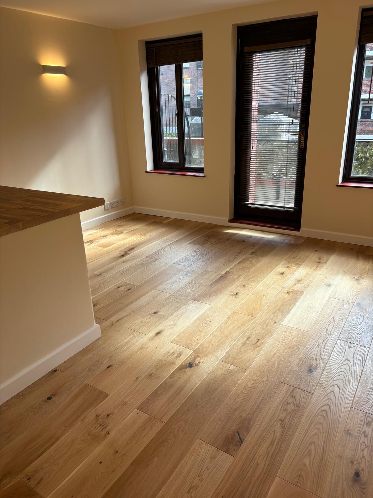 Opened up kitchen to lounge, removed stud wall, redecoration and new engineered wood floor and skirting throughout..