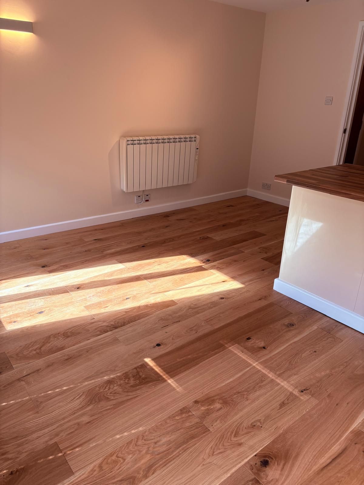 Opened up kitchen to lounge, removed stud wall, redecoration and new engineered wood floor and skirting throughout..