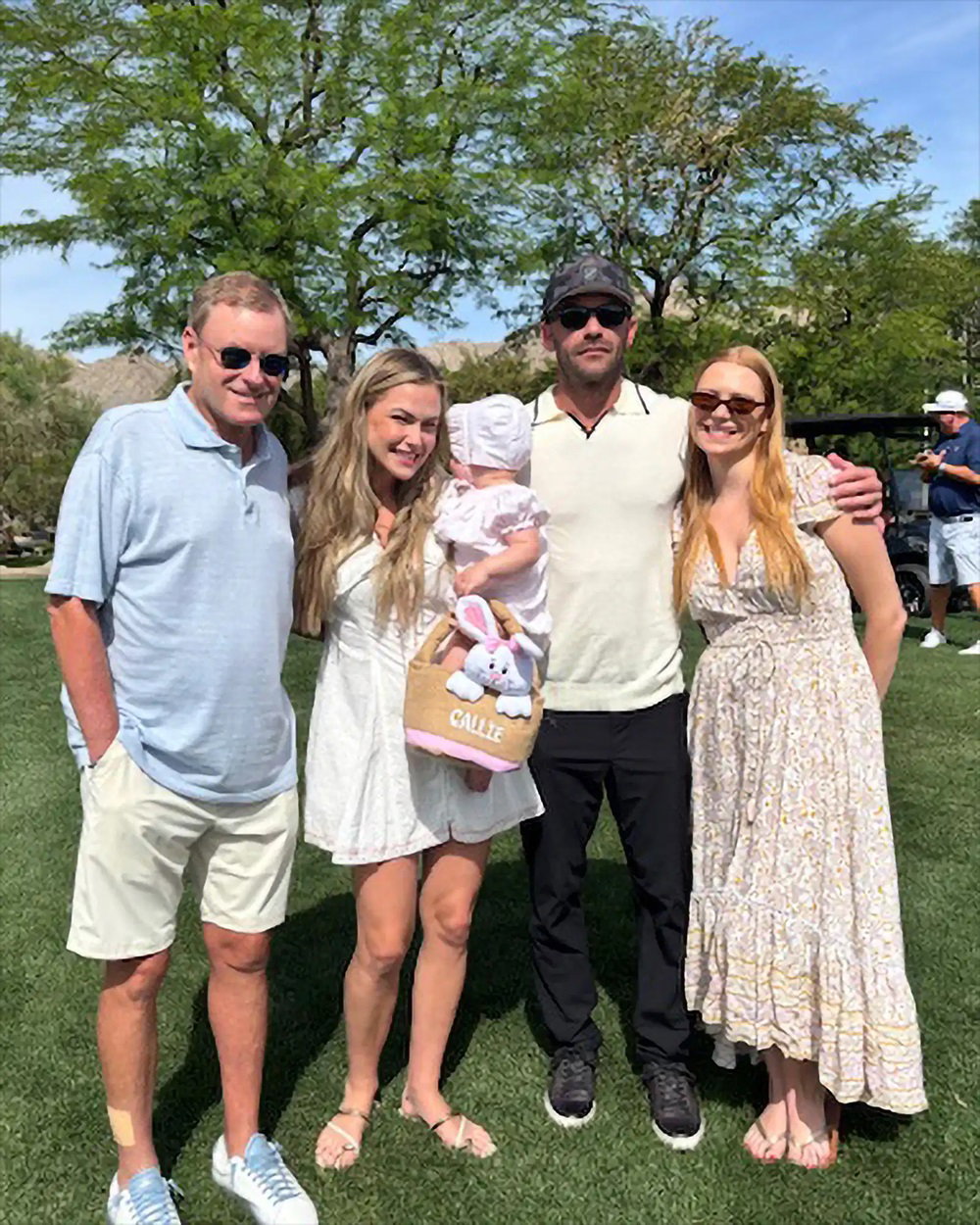 Devin Doyle with family members posing together on a green lawn outdoors