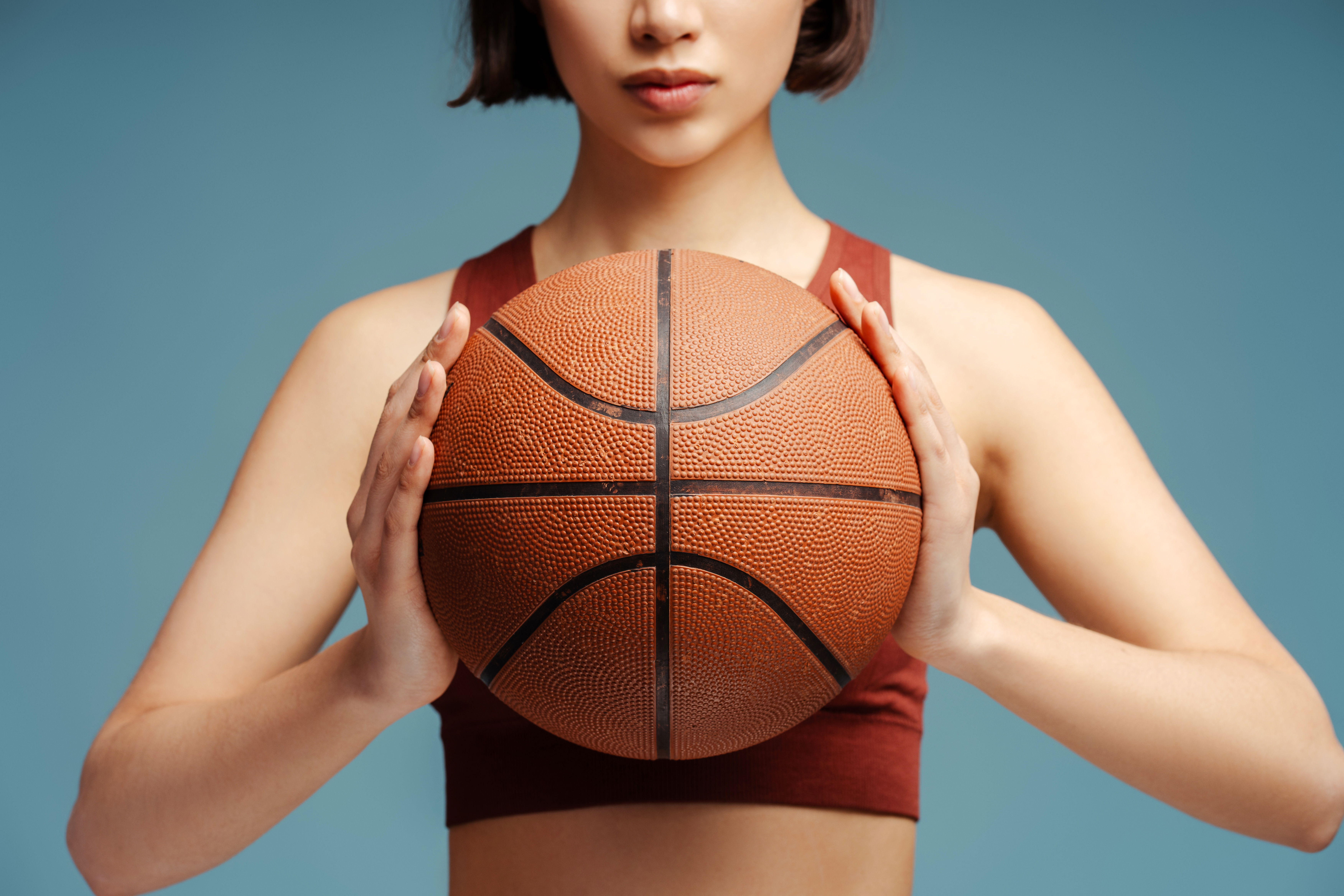 Stunning lady holding a basketball