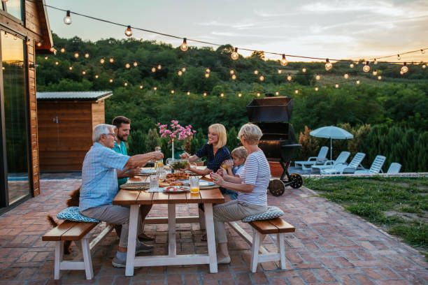 Multi-generational family sitting together outdoors
