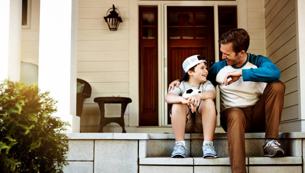 Parents sitting on a porch with their kids
