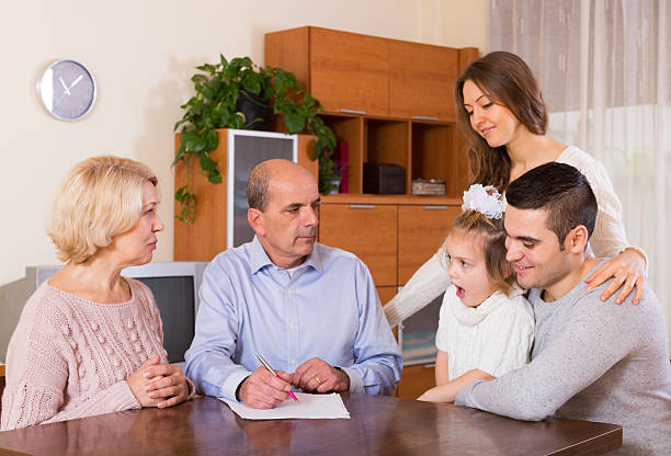 Family gathered around a table discussing documents