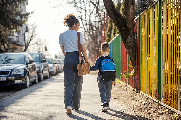 Single parent walking a child to school