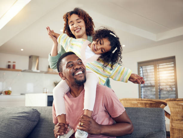 Parent playing with young children in the living room