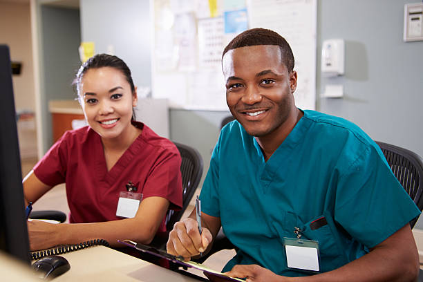 Healthcare worker smiling at a nurses' station