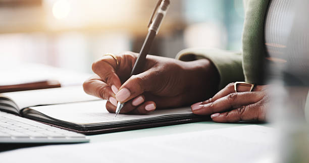 Person reviewing a policy document with a pen in hand