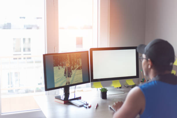 Professional working at a dual-monitor desk setup
