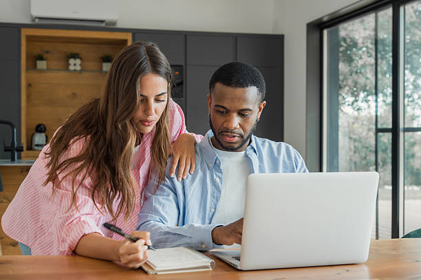 Millennial couple reviewing finances at home