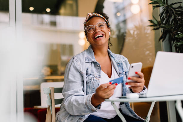 Young adult checking their phone at a coffee shop