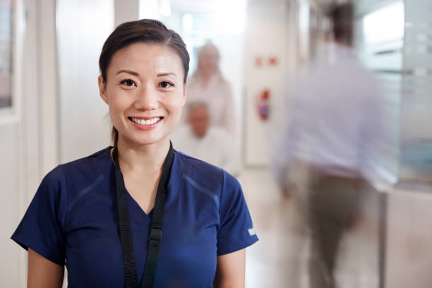 Nurse in scrubs standing in a hospital hallway