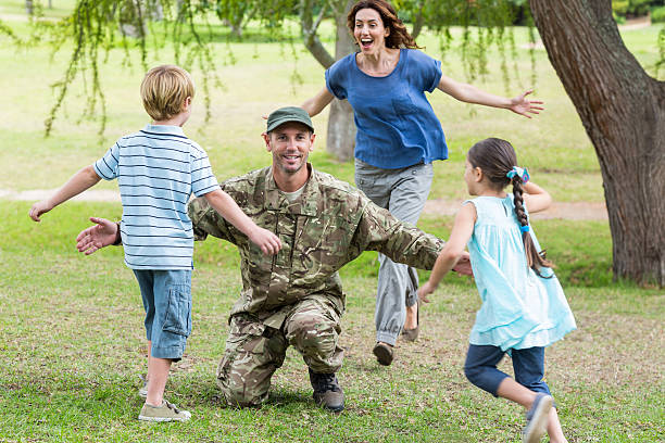 Army veteran playing with children in a yard