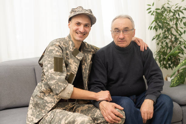 Retired veteran sitting with family in their living room