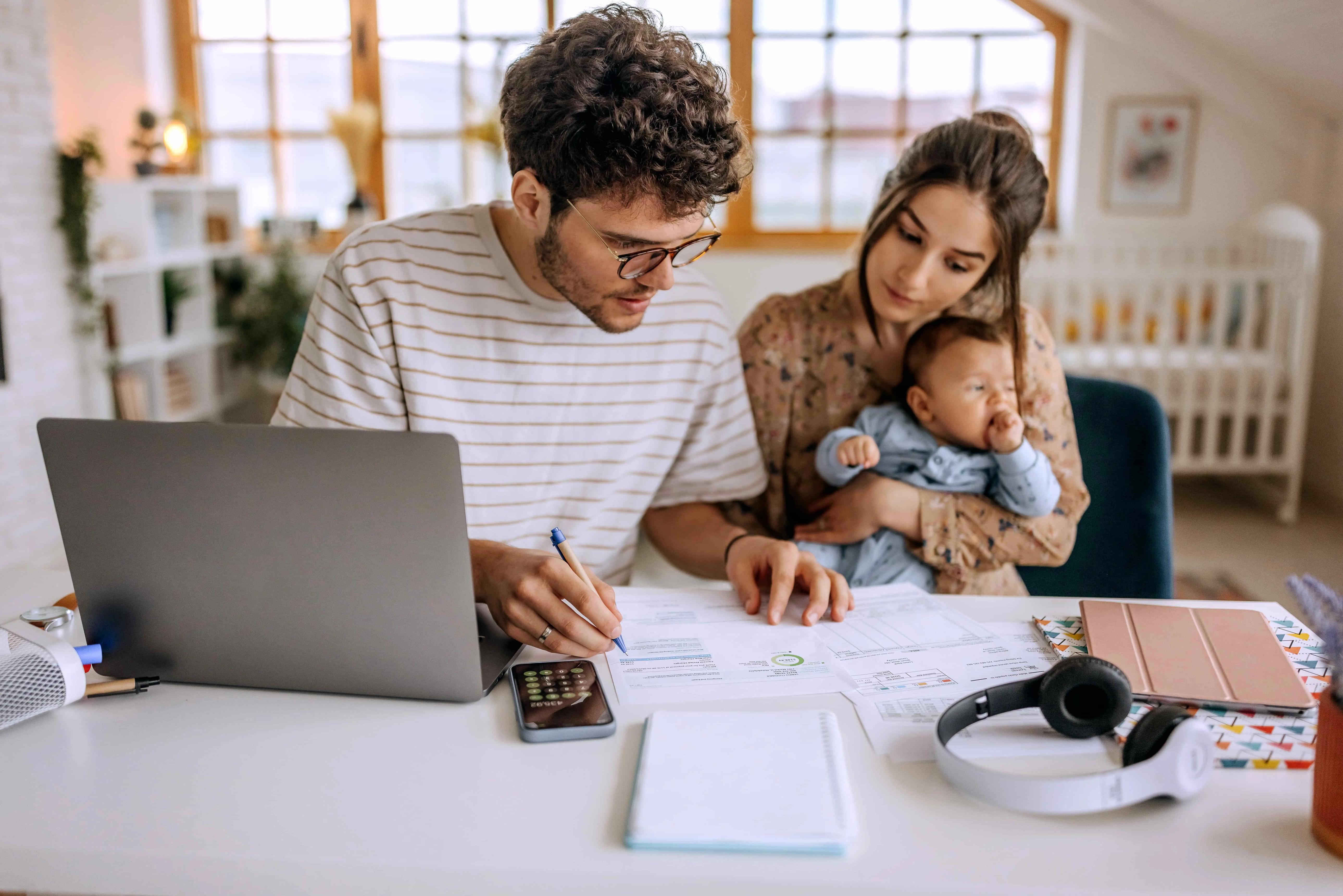 New parents reviewing a life insurance policy together at home