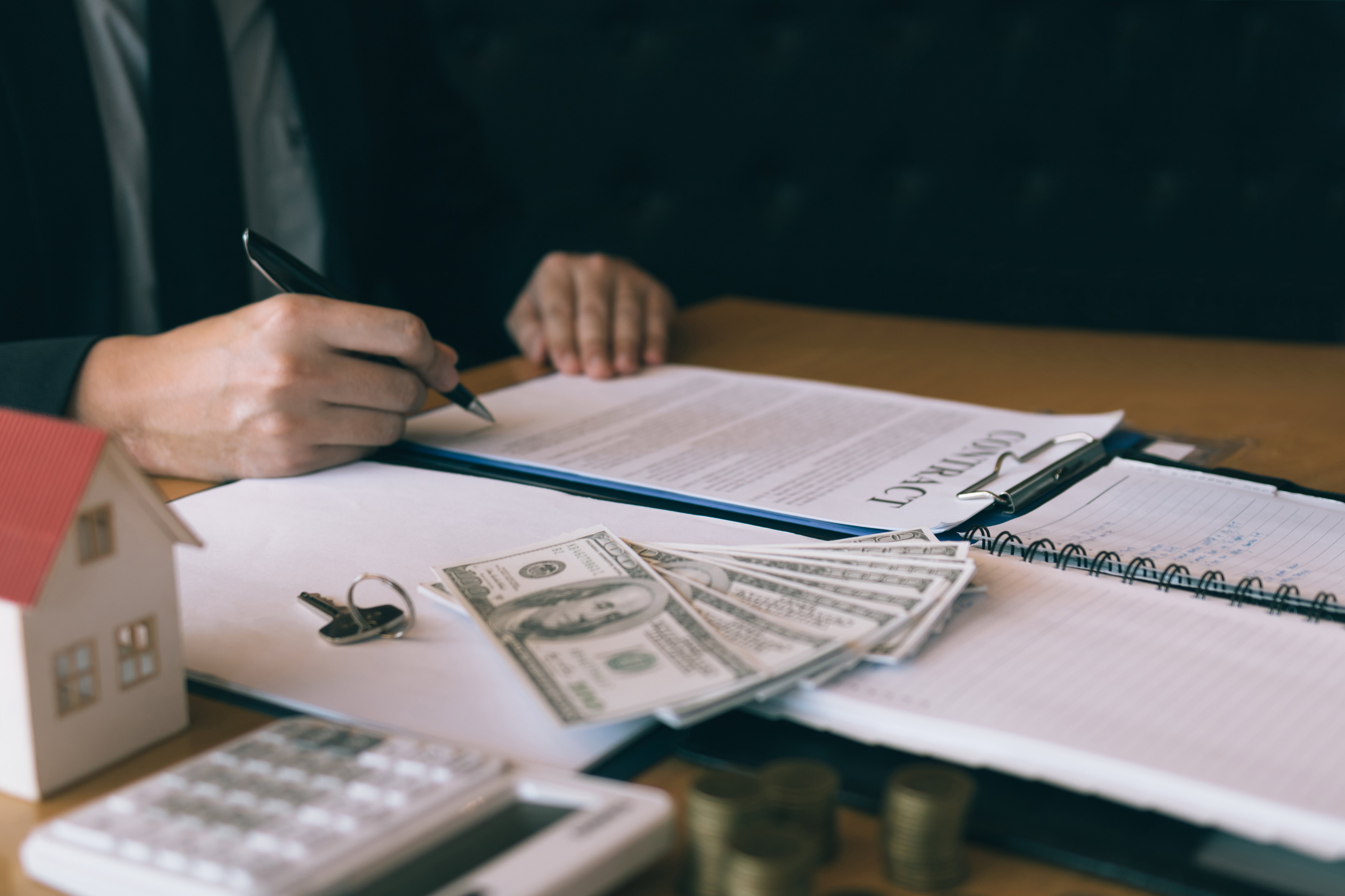 Person reviewing life insurance policy documents and cash value statement at a desk
