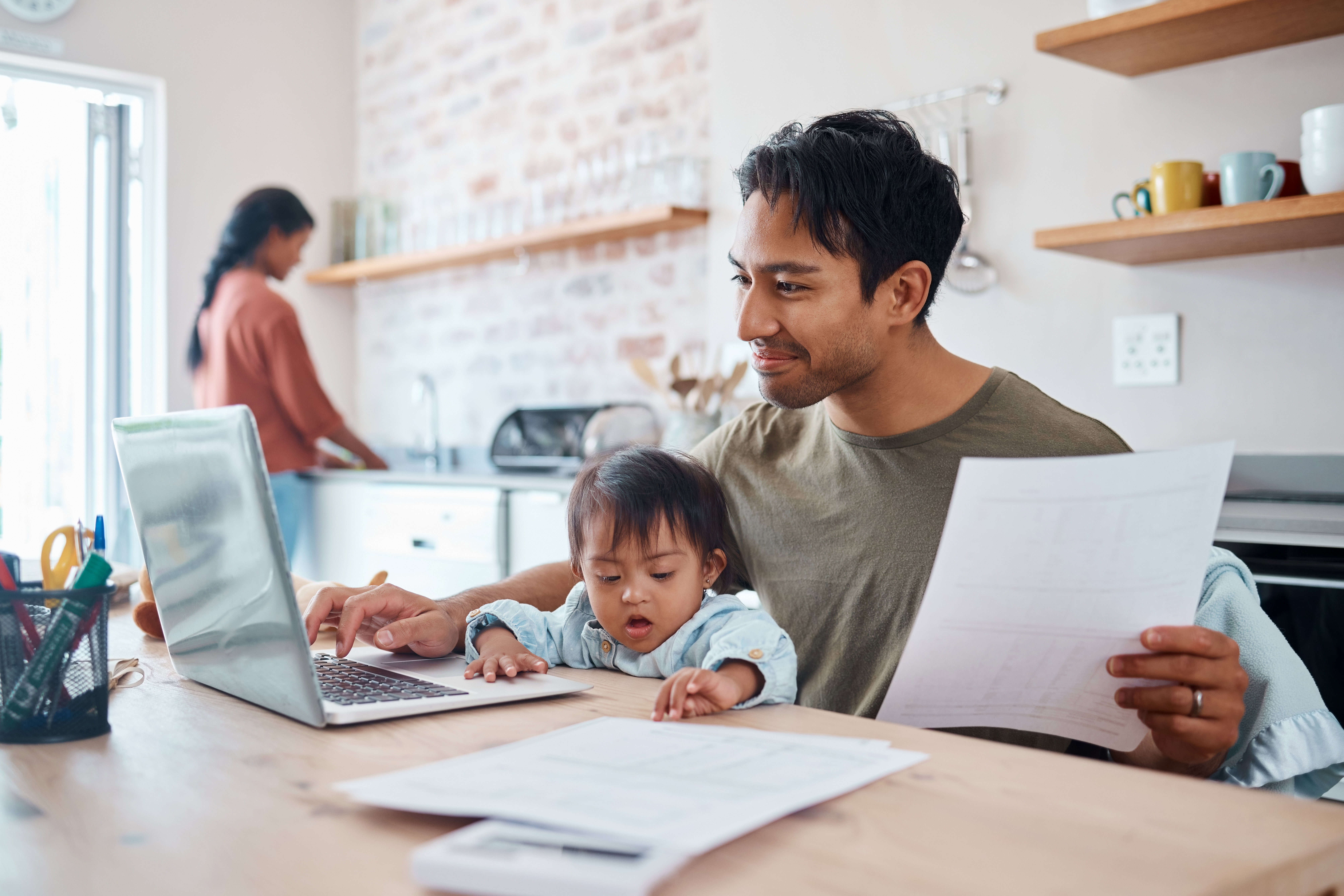 New parents reviewing a life insurance policy together at home