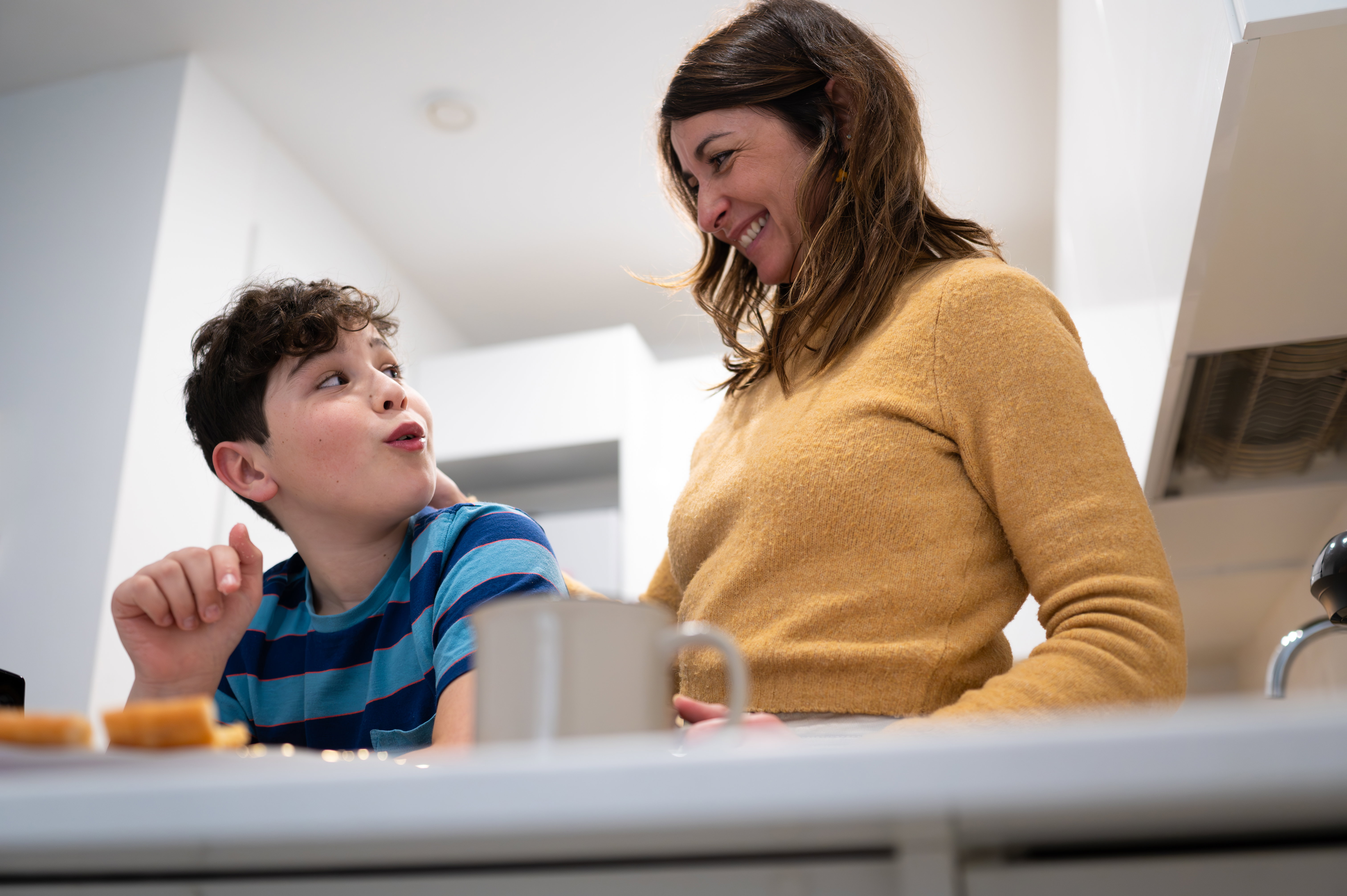 Parent and child sitting together at a kitchen table